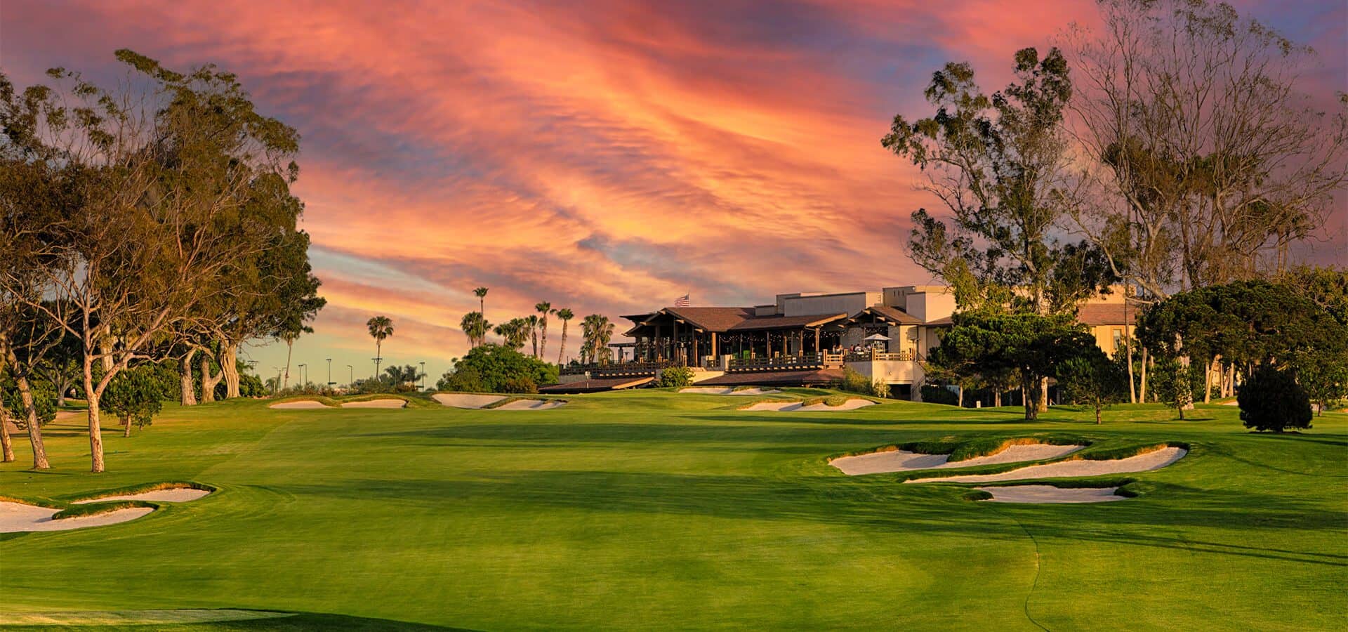 Fairway, clubhouse and renovated bunkers at Newport Beach Country Club near sunset.