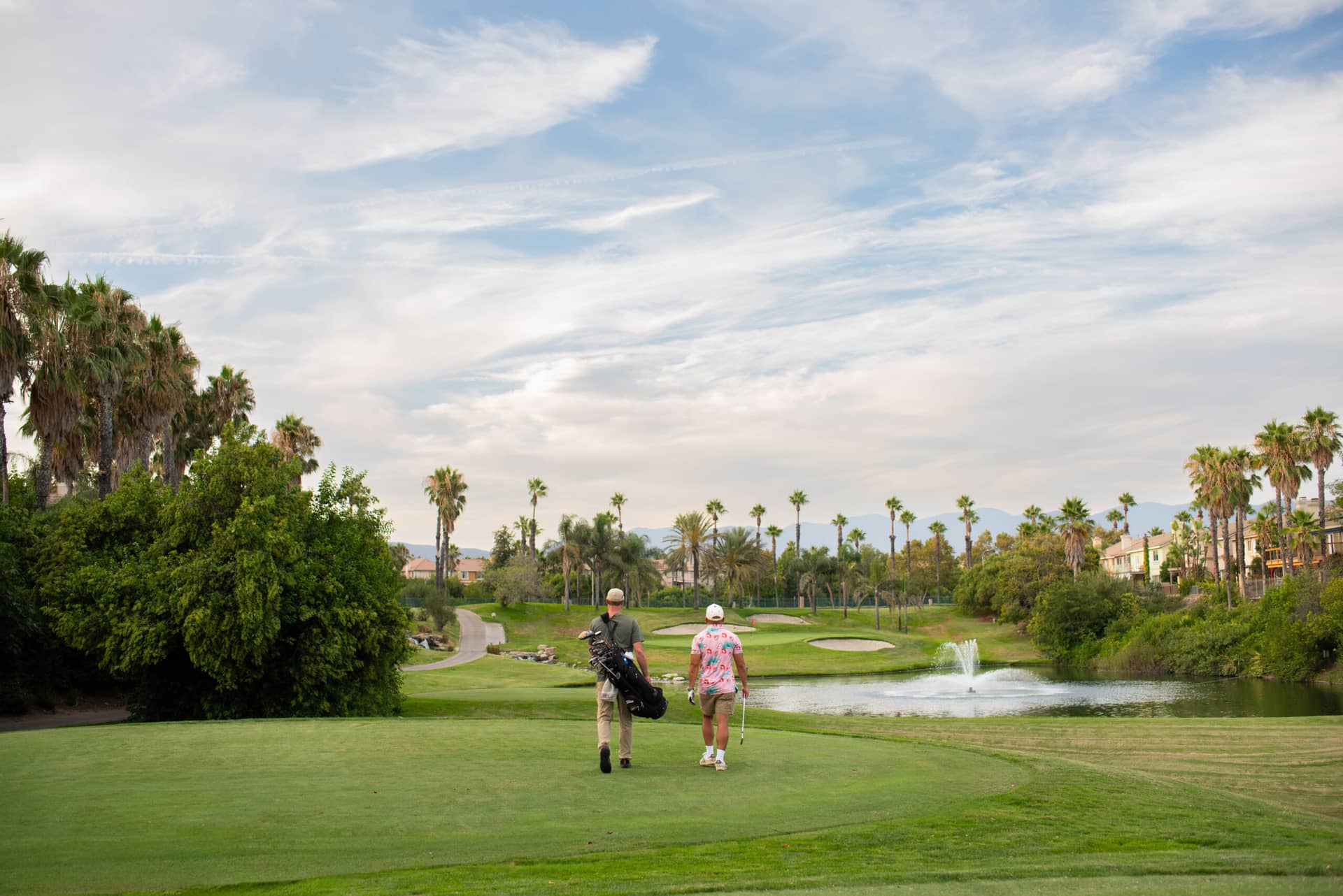 Sierra Lakes Golf Club course photograph, golfers by the lake and green.