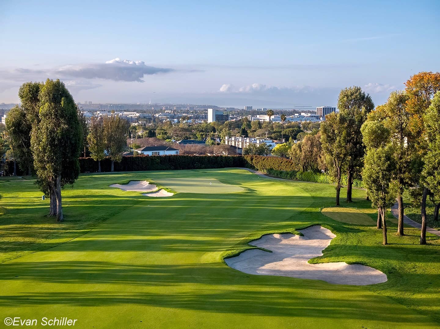 Brentwood Country Club, Los Angeles - fairway and bunkering with the West LA skyline beyond. Credit: Evan Schiller (golfshots.com), via originsgolfdesign.com. Used for editorial coverage on a non-commercial site.