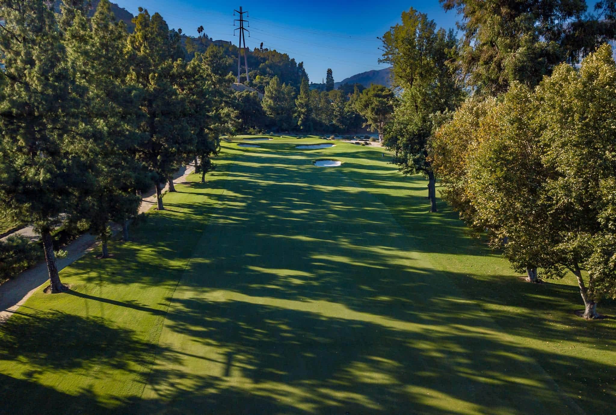 Fairway winding through the tree-lined Max Behr layout at Oakmont Country Club in Glendale.