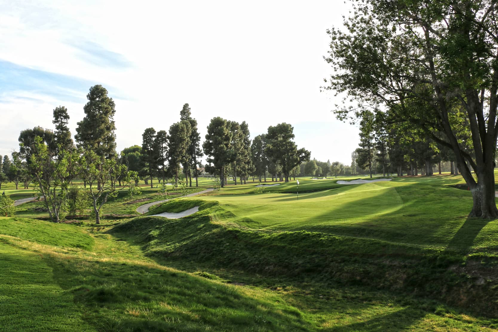 Brentwood Country Club, Los Angeles - the signature barranca fronting a green complex with sand bunkers. Credit: Origins Golf Design (Todd Eckenrode), originsgolfdesign.com. Used for editorial coverage on a non-commercial site.