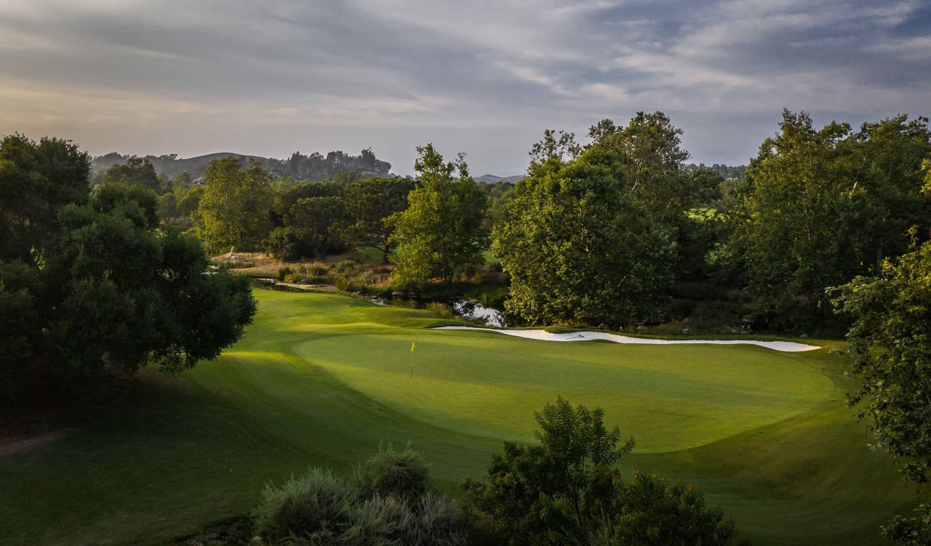 Green shaded by trees at Shady Canyon Golf Club.