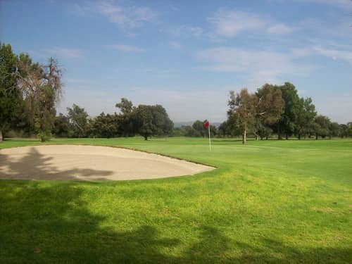 On-course view of Whittier Narrows River/Pine Course: Pine nine bunker and green.