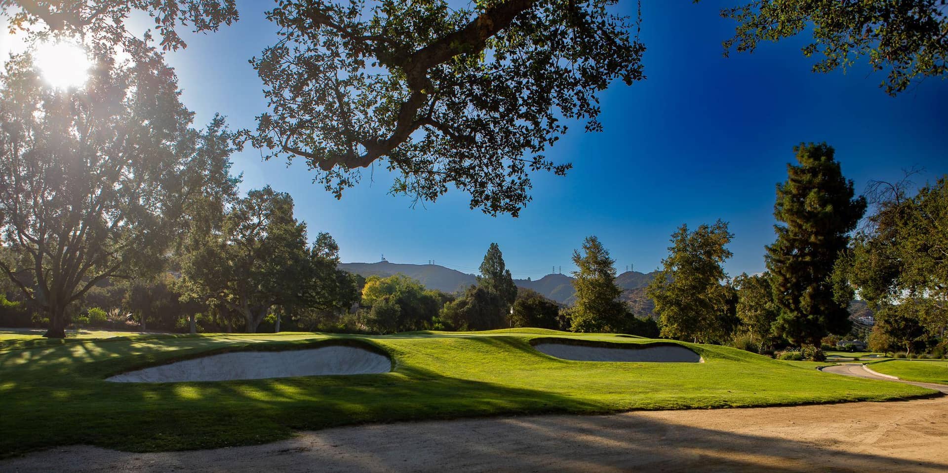 Rough-edged bunkering guarding a green at Oakmont Country Club in Glendale.